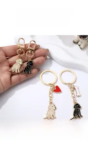 Detail of cartoon golden retriever metal keychain with red heart and bone charms