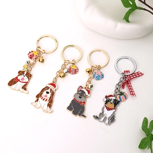Cute Christmas dog keychains featuring diverse breeds with festive hats and bells