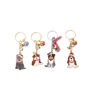 Set of four festive Christmas dog keychains featuring various cartoon puppy breeds