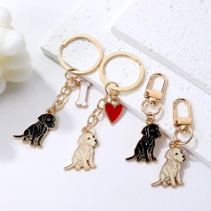 Golden Retriever dog keychain charm with heart and bone charms on white background