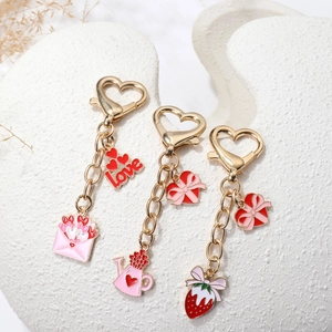 Three creative gold heart keychains with love letter and strawberry for bag decoration