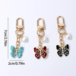 Porte-clés papillon élégant avec perles et cristaux en couleurs rouge, bleu et noir