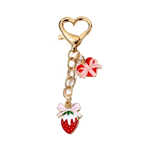 Sweet heart and strawberry keychain pendant with pink bows on a golden carabiner