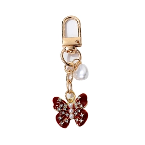 Porte-clés papillon élégant avec émail rouge, perles et strass brillants pour femmes et filles