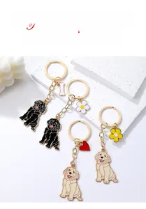 Close-up of Golden Retriever metal keychains with bone and heart shaped pendants