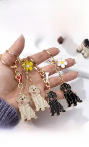 Detailed view of four golden retriever enamel keychains in assorted colors with floral charms
