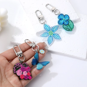 Blue acrylic floral and butterfly keychain pendant with metallic lobster clasp charm