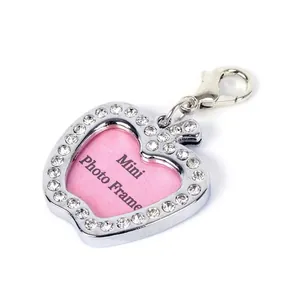 Macro detail of heart-shaped photo frame pet tag with sparkling rhinestones and clasp