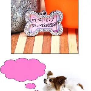 Macro detail of bone-shaped pet ID tag with rhinestones and custom engraving example