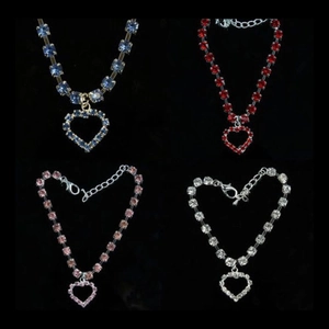 Detail view of heart-shaped pet necklaces in blue, red, pink, and white crystal colors