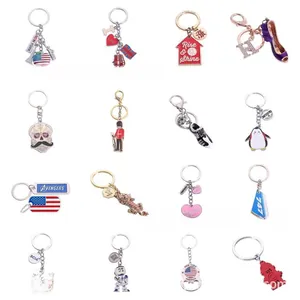 Collection of alloy enamel keychains with diverse themes like city travel and movie icons