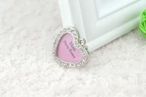 Macro shot of heart-shaped mini photo frame pendant with sparkling crystal diamonds
