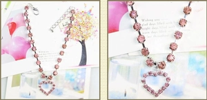 Close-up of pink rhinestone heart pendant and adjustable pet necklace chain
