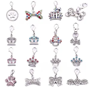 Macro view of 16-piece set of silver zinc alloy rhinestone pet charms with lobster clasps