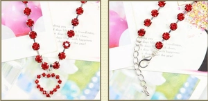 Detail of red rhinestone heart pendant pet necklace with silver lobster clasp and chain