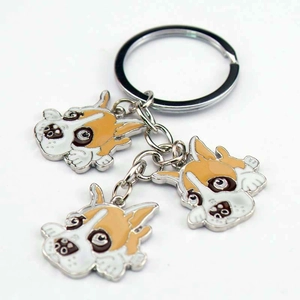 Detailed macro view of metal key ring featuring three colorful enamel bulldog charms