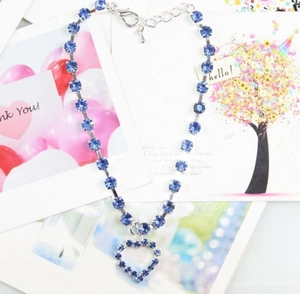 Detailed view of blue rhinestone heart pendant pet necklace on greeting cards