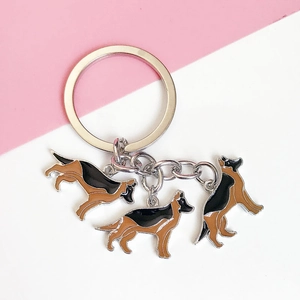 Detailed macro view of German Shepherd alloy charms on a silver metal keychain