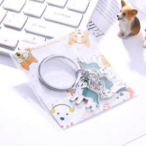 Close-up of husky dog charms keychain with colorful oil drop craft on white keyboard