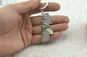Macro view of zinc alloy pug pendant showing colorful enamel front and textured back