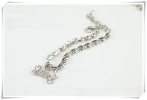 Close-up of a silver pet necklace featuring a double-row rhinestone chain and a bone pendant