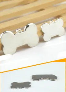 Macro view of bone-shaped zinc alloy pet ID tags in two sizes with a polished silver finish