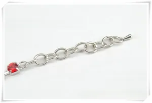 Close-up of 5cm silver extension chain with a red rhinestone and teardrop pendant