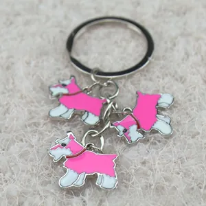 Detail of Scottie Dog keychain with three pink and white enamel charms on a silver chain