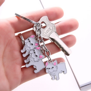 Cute white French Bulldog metal keychain with silver plating and pink ear details on ring