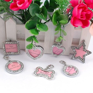 Detailed view of silver rhinestone pet photo frame charms in heart and star shapes