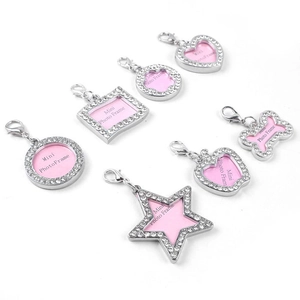 Macro view of rhinestone-studded pet ID tags in various heart and bone shapes