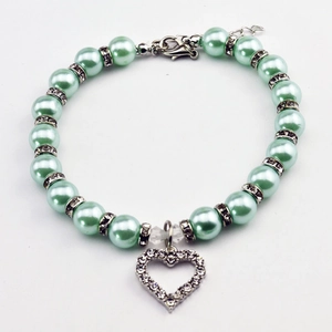 Close-up of mint green pearl pet necklace with sparkling heart rhinestone pendant