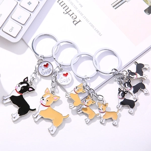 Close-up of cartoon dog metal keychains with I Love Dogs charms on a white desk