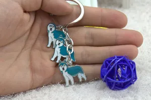 Detailed view of three husky dog enamel charms on a silver metal keychain accessory