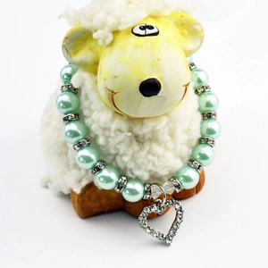 Detail of mint green pearl pet necklace featuring a sparkling rhinestone heart pendant
