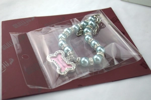 Detail of light blue pearl pet collar with rhinestone spacers and bone photo frame charm
