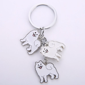Detailed view of silver alloy keychain with three white Samoyed dog enamel pendants