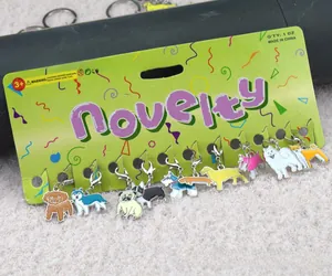 Detailed set of twelve varied enamel cartoon dog keychains on a green novelty display card