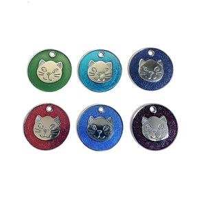 Detail view showing six colorful glittery cat-shaped pet charms with metallic relief