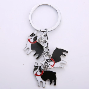 Cartoon Boston Terrier metal keychain with three black and white dog pendants on a silver ring