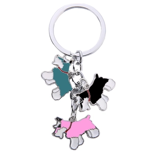 Detail of metal keychain featuring three colorful enamel dog pendants in silver finish