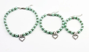 Three sizes of mint green pearl pet necklaces with rhinestone heart pendants and extension chains