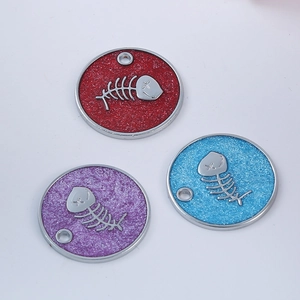 Macro shot of colorful round fishbone pet ID tags with sparkling enamel finish and metal frame