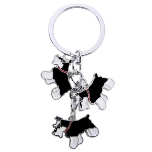 Detailed view of Schnauzer metal keychains with black and white drip oil dog charms