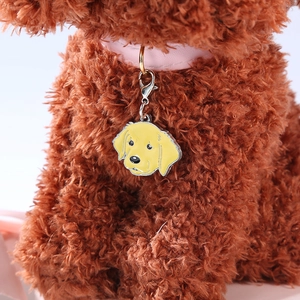 Golden retriever dog tag pendant with pink collar on brown plush background