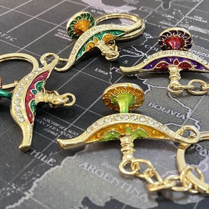 Macro shot of colorful enamel Aladdin lamp keychains with rhinestones and gold plating