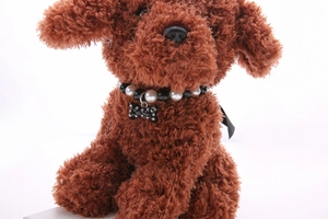 Detail of pearl pet collar with rhinestone bone pendant on a small toy dog model