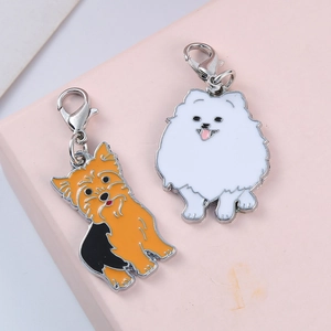 Detail view of cute cartoon Yorkshire and Pomeranian enamel pet charms with lobster clasps