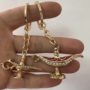 Golden Aladdin magic lamp keychains with red enamel and crystals, decorative souvenir
