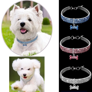 Detailed view of rhinestone pet collars with bone pendants in blue, red and silver